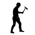 Silhouette of a worker in action pose using his axe tool. Royalty Free Stock Photo