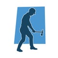 Silhouette of a worker in action pose using his axe tool. Royalty Free Stock Photo