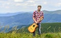 Silence of mountains and sound of guitar strings. Hipster musician. Inspiring environment. Summer music festival