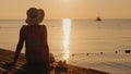 Silence and pacification in the early morning on the sea pier, the girl enjoys loneliness