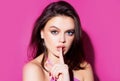 Silence. Woman silence or secrecy with finger on lips hush hand gesture on pink background. Pretty girl placing fingers Royalty Free Stock Photo