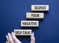 Silence your negative self-talk symbol. Concept words Silence your negative self-talk on wooden blocks. Doctor hand. Beautiful Royalty Free Stock Photo