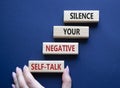 Silence your negative self-talk symbol. Concept words Silence your negative self-talk on wooden blocks. Doctor hand. Beautiful Royalty Free Stock Photo