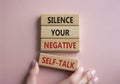 Silence your negative self-talk symbol. Concept words Silence your negative self-talk on wooden blocks. Doctor hand. Beautiful Royalty Free Stock Photo