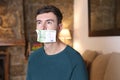 Silenced man with money covering mouth