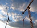 Silent Construction Cranes and Clouds