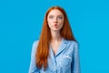 Silent like fish. Cute and funny young redhead female with long ginger hair, sucking lips as mimicking, fooling around