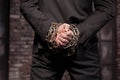 Silent murderer hands in iron chain, back view Royalty Free Stock Photo