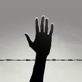 Silent plea Human hand silhouette reaches out, silently asking for help