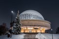 Silesian Planetarium during the blue hour. Beautiful winter scenery. The snow-covered dome of the observatory