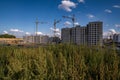 silhoette of tower cranes on construction site, providing housing for low-income citizens of third world countries