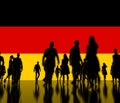 Silhoettes of unknown men and women on the flag of Germany background. 3d rendering