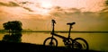 Silhouete a bicycle behind a lake