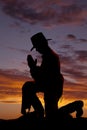 Silhouete cowboy kneel head down. Royalty Free Stock Photo