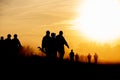 Silhouette action soldiers walking hold weapons the background is smoke and sunset and white balance ship effect dark Royalty Free Stock Photo