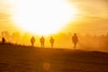 Silhouette action soldiers walking hold weapons the background is smoke and sunset and white balance ship effect dark Royalty Free Stock Photo