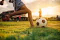 Silhouette action sport outdoors of diversity of kids having fun playing soccer football for exercise in community rural area unde