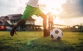 Silhouette action sport outdoors of diversity of kids having fun playing soccer football for exercise in community rural area unde