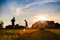 Silhouette action sport outdoors of kids having fun playing soccer football for exercise in community rural area under the twiligh