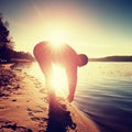 Silhouette of active man running and exercising on the beach at sunset. Royalty Free Stock Photo