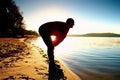 Silhouette of active man running and exercising on the beach at sunset. Royalty Free Stock Photo