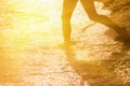 Silhouette of adorable little girl on the beach against water of sea. Summer holiday concept. Horizontal image