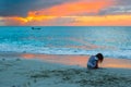 Silhouette of adorable little girl on the beach at sunset