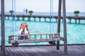 Silhouette of adorable little girl on a swing at