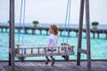 Silhouette of adorable little girl on swing at