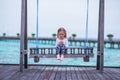 Silhouette of adorable little girl on swing at