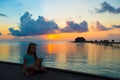 Silhouette of adorable little girl on wooden jetty