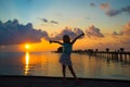 Silhouette of adorable little girl on wooden jetty