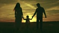 silhouette affectionate parents with child sunset. happy african family sunset park. mother father hold kid hands Royalty Free Stock Photo