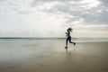 Silhouette of African American woman running on the beach - young attractive and athletic black girl training outdoors doing Royalty Free Stock Photo