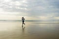 Silhouette of African American woman running on the beach - young attractive and athletic black girl training outdoors doing Royalty Free Stock Photo