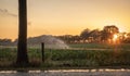 Silhouette of agricultural irrigation system watering cornfield at sunset. Cornfield irrigation using the center pivot sprinkler Royalty Free Stock Photo