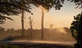 Silhouette of agricultural irrigation system watering cornfield at sunset. Cornfield irrigation using the center pivot sprinkler Royalty Free Stock Photo