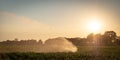 Silhouette of agricultural irrigation system watering cornfield at sunset. Cornfield irrigation using the center pivot sprinkler Royalty Free Stock Photo