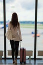 Silhouette of airline passenger in an airport lounge waiting for flight aircraft Royalty Free Stock Photo