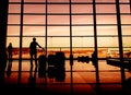 Silhouette of airline passengers in an airport Royalty Free Stock Photo