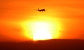 Silhouette of airplane departing arriving during sunset at tropical paradise Bali Indonesia.