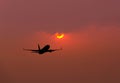 Silhouette airplane flying take off on sunset . Royalty Free Stock Photo