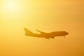 Silhouette of airplane in the orange sky
