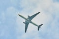 Silhouette of an airplane on sky background. Commercial airplane jetliner flying above clouds in beautiful day light. Flight trave Royalty Free Stock Photo