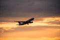 Silhouette of airplane at sunset.