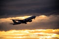 Silhouette of airplane at sunset.