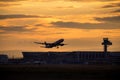 Silhouette of airplane at sunset.