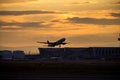 Silhouette of airplane at sunset.