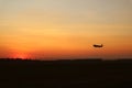 Silhouette of an airplane taking off to the sunset sky Royalty Free Stock Photo