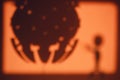 The silhouette of an alien ship and the shadow of a humanoid on the background of moonlight